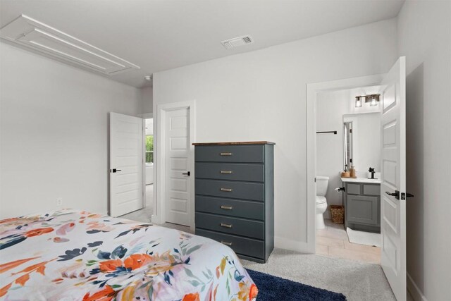 1213 Silver Dollar Trl, Georgetown, TX 78628 - bedroom featuring attic access, light colored carpet, ensuite bath, and baseboards