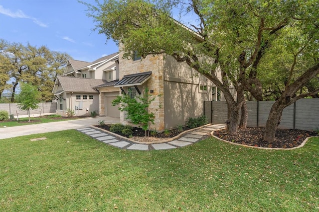 1213 Silver Dollar Trl, Georgetown, TX 78628 - view of front of property featuring a standing seam roof, stone siding, driveway, a garage, and metal roof