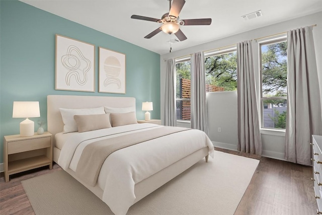 1213 Silver Dollar Trl, Georgetown, TX 78628 - bedroom featuring wood finished floors, a ceiling fan, and baseboards