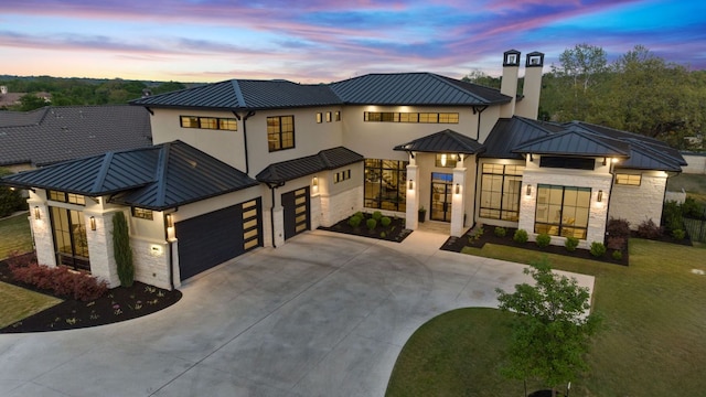 108 Fishspear Ln, Georgetown, TX 78628 - view of front of property featuring a standing seam roof, metal roof, stone siding, driveway, and an attached garage