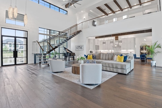 108 Fishspear Ln, Georgetown, TX 78628 - living area featuring a high ceiling, stairway, dark wood-style flooring, baseboards, and a ceiling fan