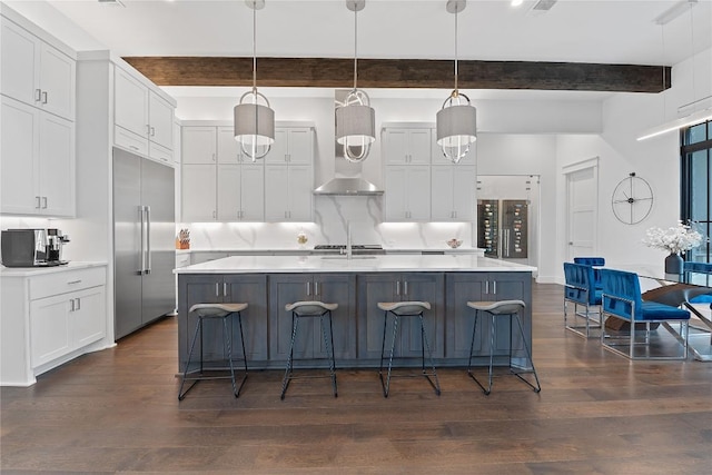 108 Fishspear Ln, Georgetown, TX 78628 - kitchen featuring built in fridge, beamed ceiling, light countertops, dark wood finished floors, and white cabinets