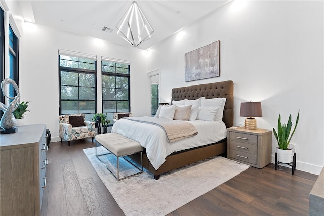 108 Fishspear Ln, Georgetown, TX 78628 - bedroom with dark wood-style flooring, a chandelier, and baseboards