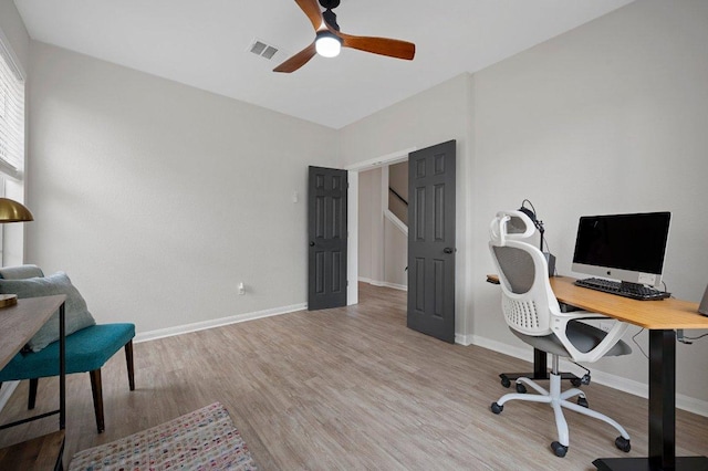 office area featuring baseboards, visible vents, wood finished floors, and ceiling fan