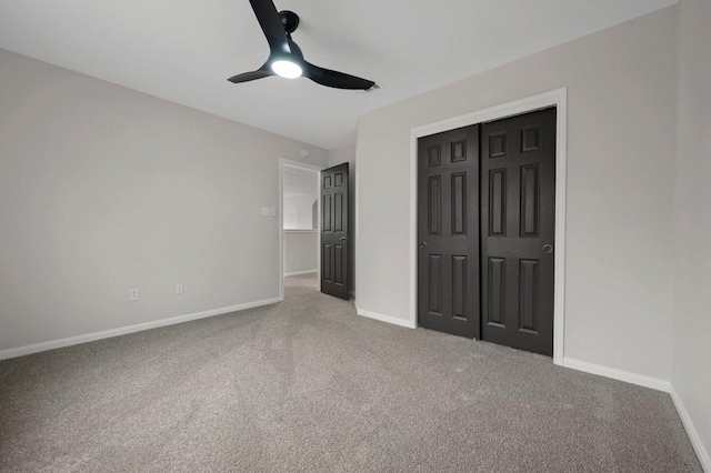 unfurnished bedroom featuring baseboards, a ceiling fan, a closet, and carpet