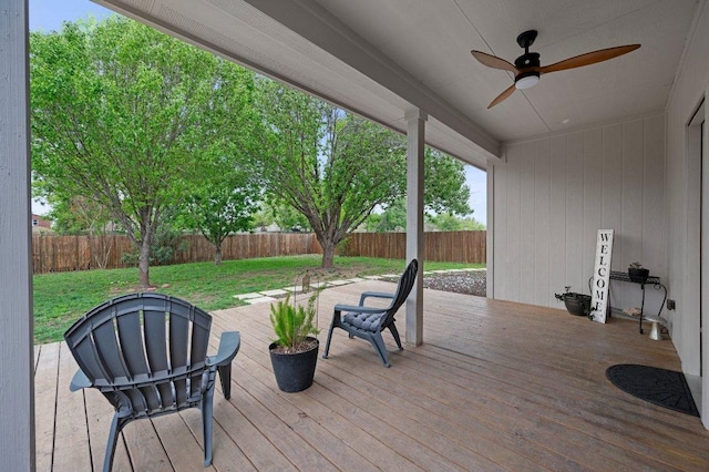 wooden deck featuring a fenced backyard, a yard, and a ceiling fan