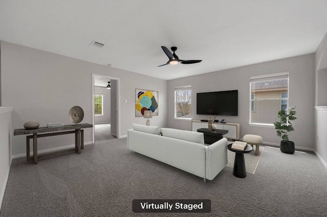 living area with a ceiling fan, carpet floors, baseboards, and visible vents