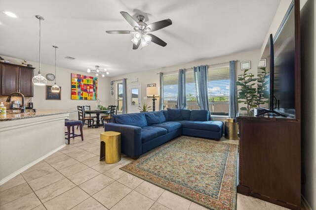 30336 Tiger Woods Dr, Georgetown, TX 78628 - living room with a ceiling fan, light tile patterned floors, a chandelier, and baseboards