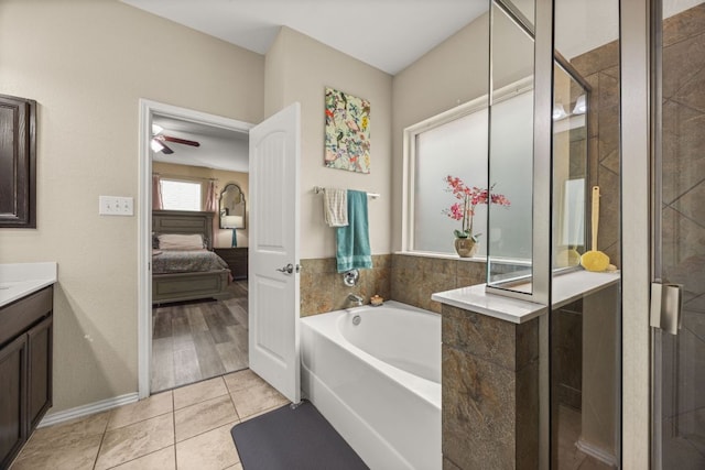 30336 Tiger Woods Dr, Georgetown, TX 78628 - ensuite bathroom with a bath, vanity, tile patterned floors, ceiling fan, and a shower stall