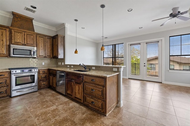 4000 Ranch Road 620 N Unit 8, Austin, TX 78734 - kitchen featuring stainless steel appliances, a sink, plenty of natural light, a peninsula, and ornamental molding