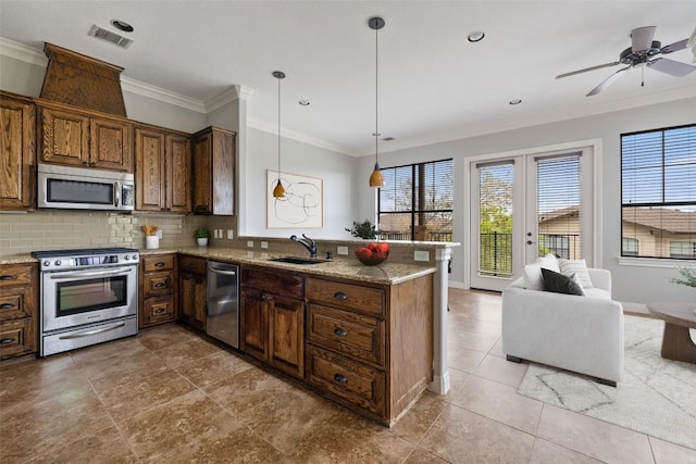 4000 Ranch Road 620 N Unit 8, Austin, TX 78734 - kitchen featuring appliances with stainless steel finishes, a sink, a peninsula, healthy amount of natural light, and crown molding