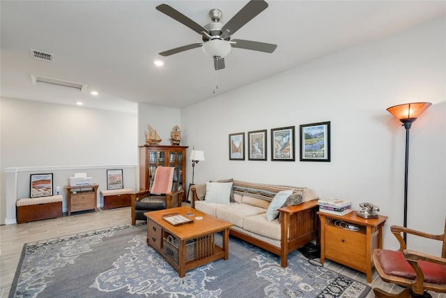 living area featuring attic access, recessed lighting, ceiling fan, visible vents, and wood finished floors