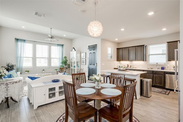 dining space with wood tiled floor, visible vents, ceiling fan, and recessed lighting