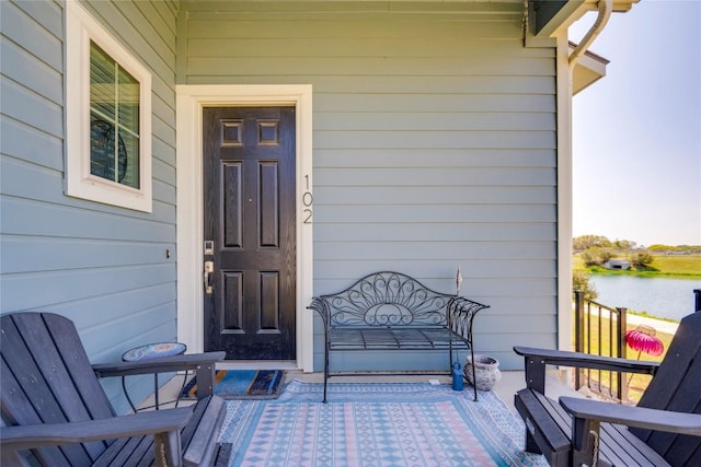 doorway to property with a water view