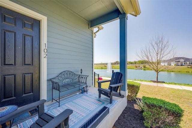 121 Harborside Dr Unit 102, San Marcos, TX 78666 - covered porch with a water view and a lawn