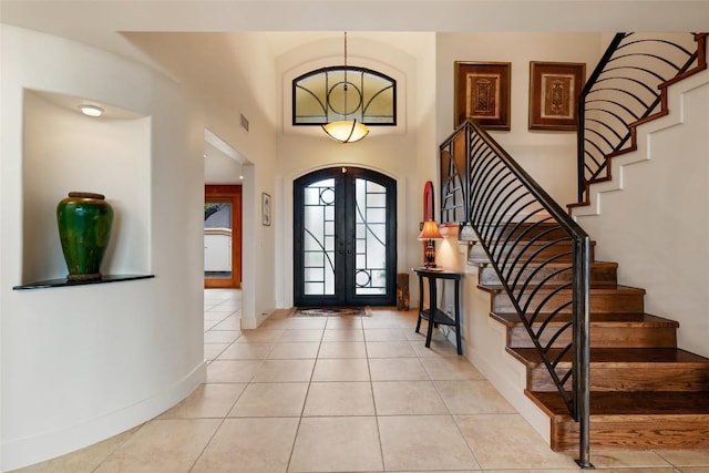 4508 Knapp Holw, Austin, TX 78731 - entryway featuring french doors, stairs, baseboards, and light tile patterned floors