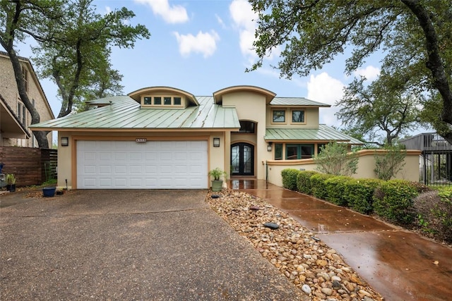 4508 Knapp Holw, Austin, TX 78731 - view of front facade with a standing seam roof, stucco siding, asphalt driveway, french doors, and metal roof