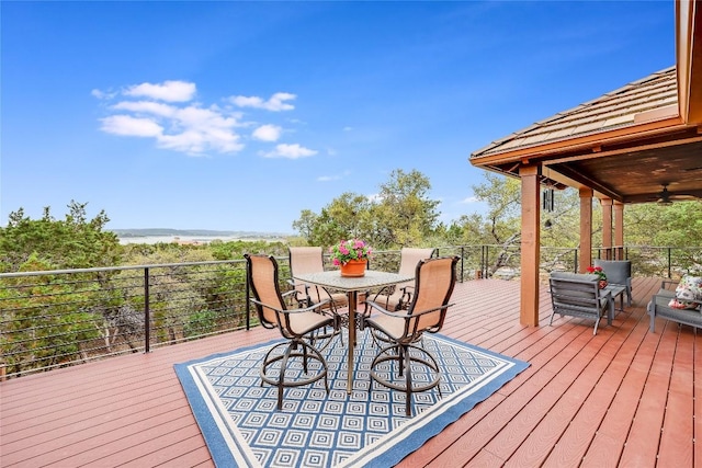 deck featuring a ceiling fan and outdoor dining area