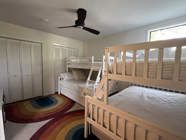 421 E Briarway Dr, Marble Falls, TX 78654 - bedroom featuring multiple closets, a ceiling fan, and a textured ceiling