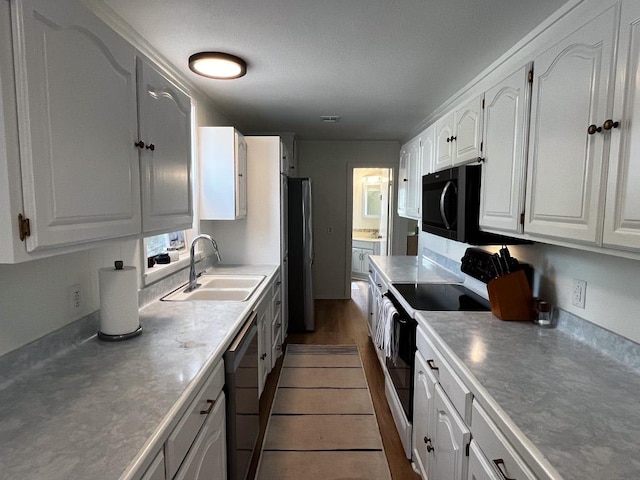 421 E Briarway Dr, Marble Falls, TX 78654 - kitchen featuring a sink, appliances with stainless steel finishes, white cabinets, light countertops, and dark wood-style floors