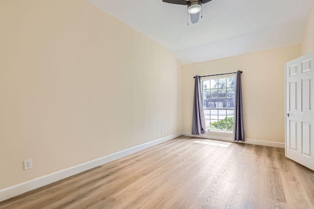 empty room with light wood finished floors, baseboards, vaulted ceiling, and ceiling fan