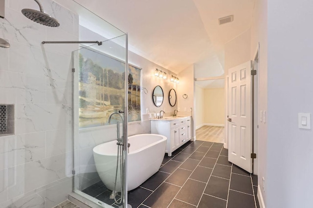 full bath featuring vanity, a shower stall, a soaking tub, lofted ceiling, and visible vents