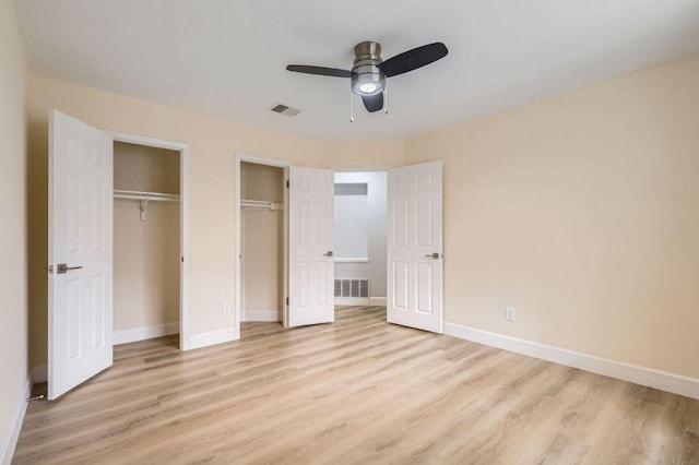unfurnished bedroom with baseboards, visible vents, and light wood-style floors