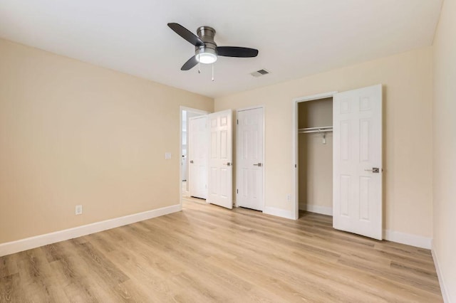 unfurnished bedroom with light wood-type flooring, baseboards, ceiling fan, and visible vents