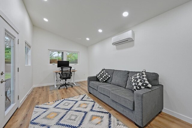7511 Saint Cecelia St, Austin, TX 78757 - living area with a wall mounted air conditioner, light wood-style flooring, an office area, recessed lighting, and baseboards