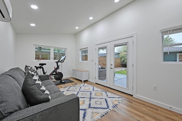 7511 Saint Cecelia St, Austin, TX 78757 - living room featuring french doors, an AC wall unit, wood finished floors, recessed lighting, and baseboards