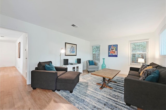 7511 Saint Cecelia St, Austin, TX 78757 - living room featuring light wood-style flooring, plenty of natural light, and baseboards