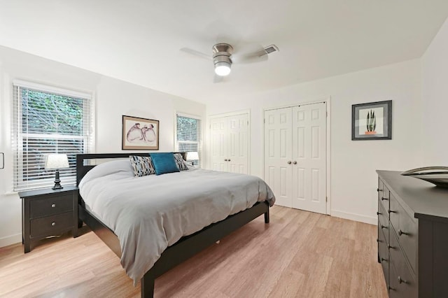7511 Saint Cecelia St, Austin, TX 78757 - bedroom with light wood-style floors, two closets, baseboards, and ceiling fan
