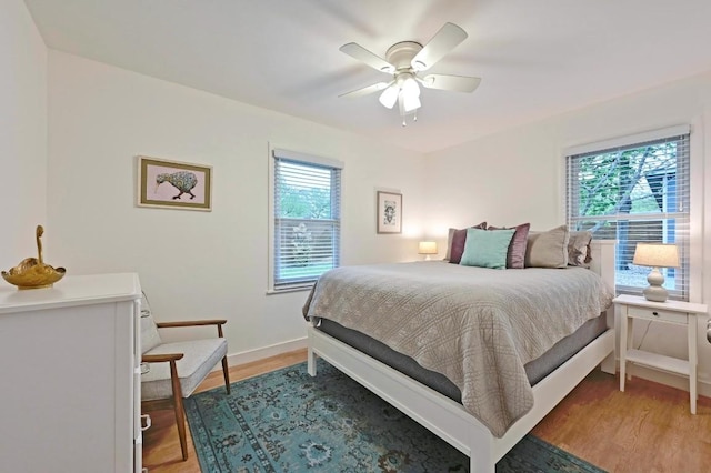 7511 Saint Cecelia St, Austin, TX 78757 - bedroom featuring light wood finished floors, baseboards, and ceiling fan