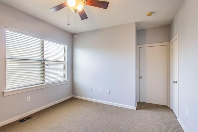 1201 Grove Blvd Unit 702, Austin, TX 78741 - unfurnished bedroom with carpet floors, baseboards, and a ceiling fan