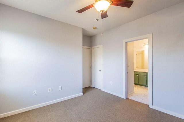1201 Grove Blvd Unit 702, Austin, TX 78741 - unfurnished bedroom featuring light carpet, ensuite bath, baseboards, and ceiling fan