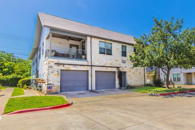 1201 Grove Blvd Unit 702, Austin, TX 78741 - townhome / multi-family property featuring stone siding, a balcony, a garage, and driveway