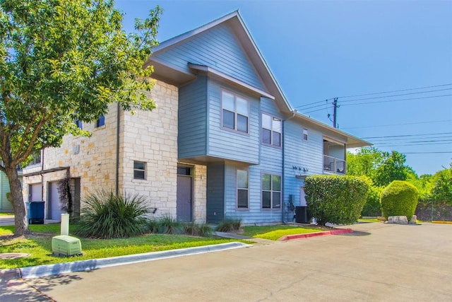 1201 Grove Blvd Unit 702, Austin, TX 78741 - view of front of home featuring stone siding and central AC