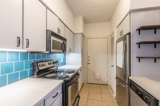 1201 Grove Blvd Unit 702, Austin, TX 78741 - kitchen with appliances with stainless steel finishes, light countertops, and white cabinets
