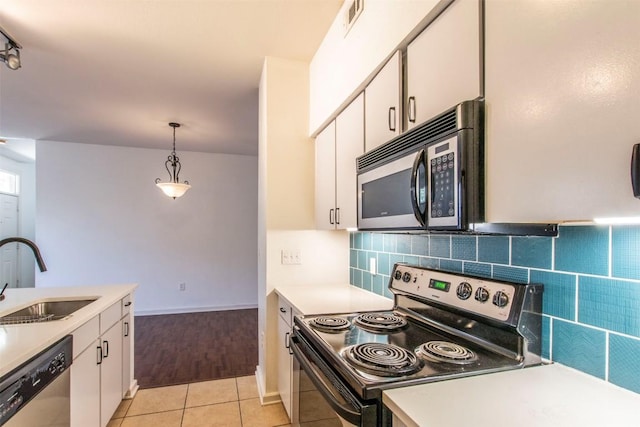 1201 Grove Blvd Unit 702, Austin, TX 78741 - kitchen featuring electric range oven, a sink, stainless steel dishwasher, light countertops, and white cabinetry