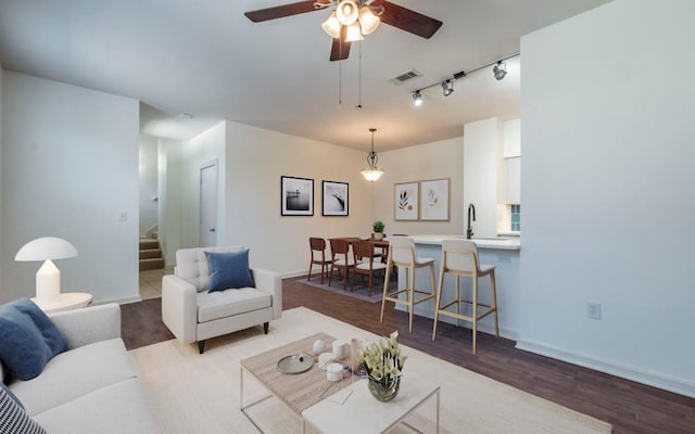 1201 Grove Blvd Unit 702, Austin, TX 78741 - living room featuring stairs, track lighting, wood finished floors, and ceiling fan