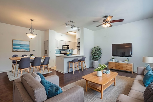 1201 Grove Blvd Unit 702, Austin, TX 78741 - living room with ceiling fan, dark wood-style floors, and rail lighting