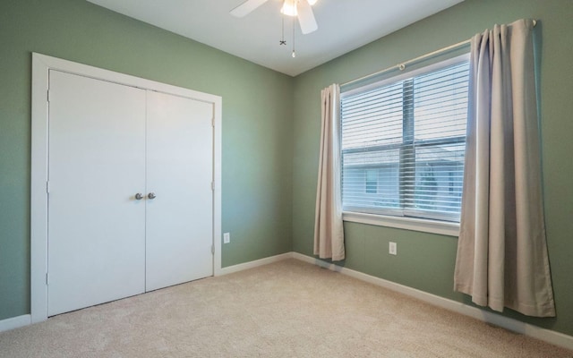 1201 Grove Blvd Unit 702, Austin, TX 78741 - unfurnished bedroom featuring carpet flooring, multiple windows, a closet, and a ceiling fan