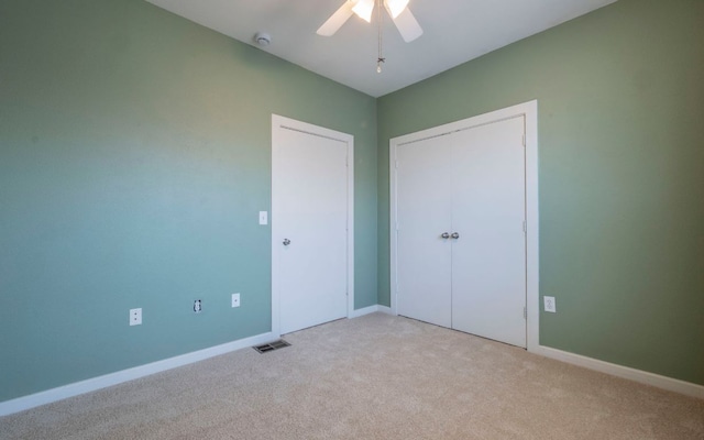 1201 Grove Blvd Unit 702, Austin, TX 78741 - unfurnished bedroom featuring light carpet, a ceiling fan, and a closet
