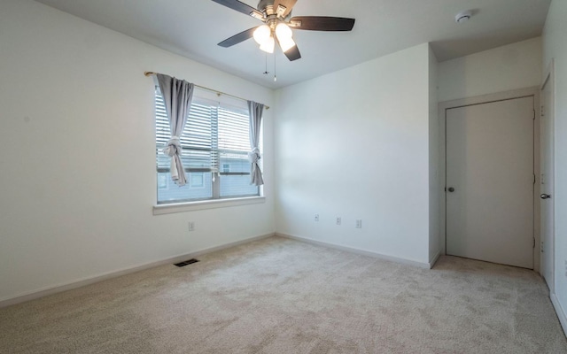 1201 Grove Blvd Unit 702, Austin, TX 78741 - empty room featuring light colored carpet, ceiling fan, and a smoke detector