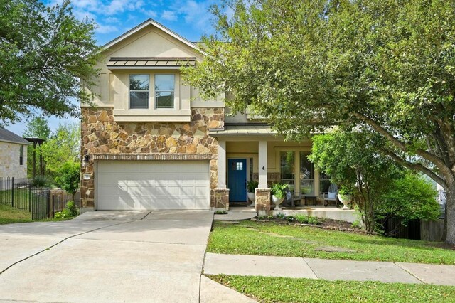 7721 Journeyville Dr, Austin, TX 78735 - view of front of home featuring stone siding, stucco siding, a standing seam roof, driveway, and an attached garage