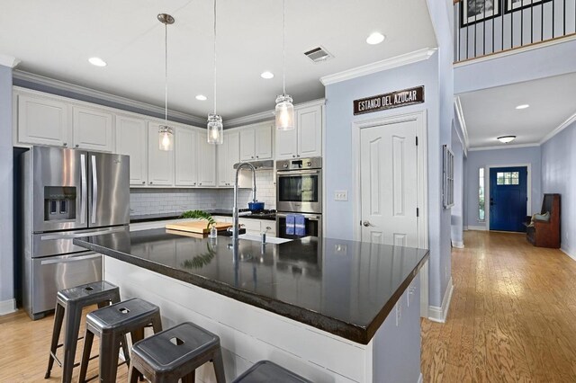 7721 Journeyville Dr, Austin, TX 78735 - kitchen with stainless steel appliances, ornamental molding, baseboards, tasteful backsplash, and white cabinets