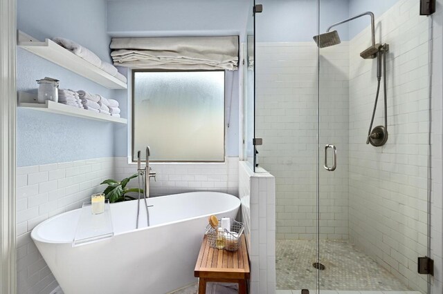 7721 Journeyville Dr, Austin, TX 78735 - bathroom with tile walls, a stall shower, and a freestanding tub