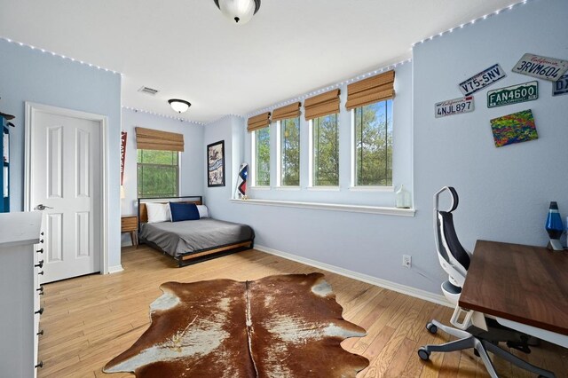 7721 Journeyville Dr, Austin, TX 78735 - bedroom featuring wood finished floors, baseboards, and a desk