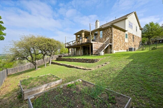 7721 Journeyville Dr, Austin, TX 78735 - back of property with a vegetable garden, stairway, a wooden deck, a chimney, and stone siding