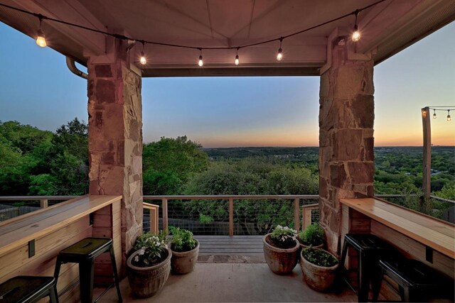 7721 Journeyville Dr, Austin, TX 78735 - balcony at dusk with a wooded view